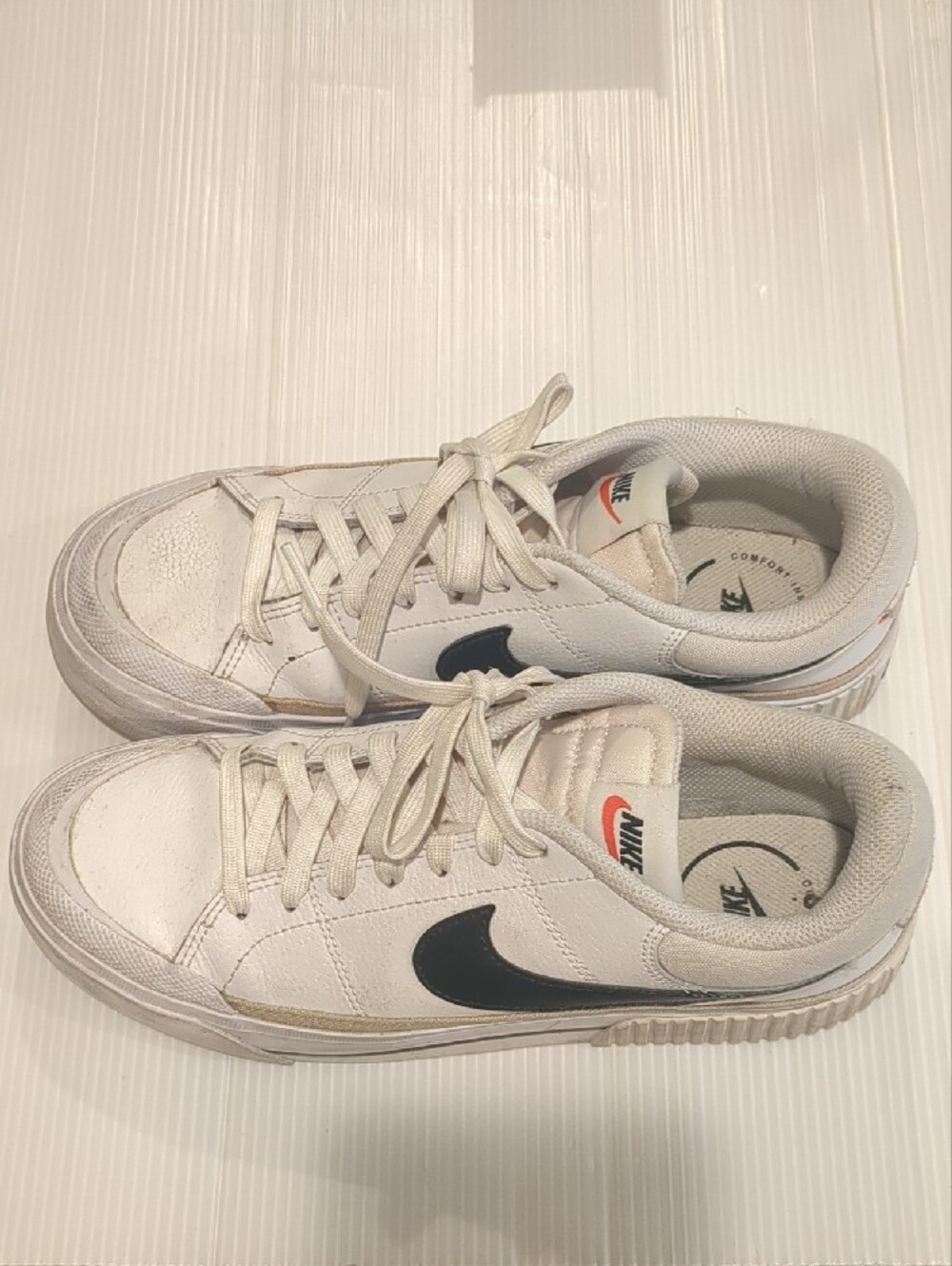 Nike White Sneakers with Black Swoosh and Red Logo